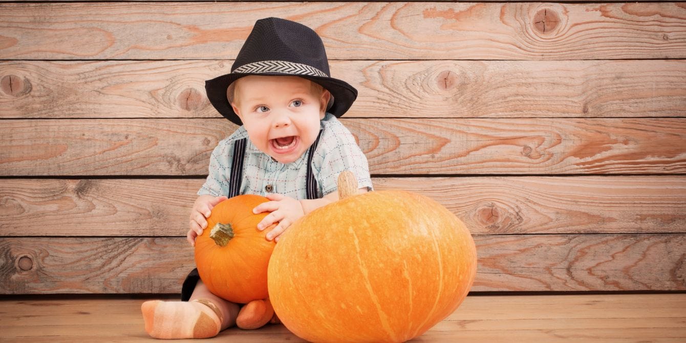20 Thanksgiving jokes for a gourd time baby holding pumpkin- thanksgiving jokes