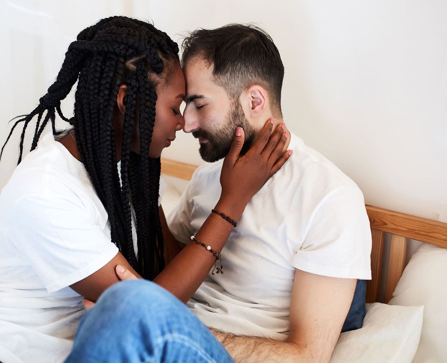 Yep, you can get pregnant during perimenopause couple hugging on the bed talking about if you can get pregnant during perimenopause