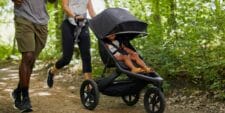 This lightweight jogging stroller checks every box—and then some family jogging with child in Guava stroller