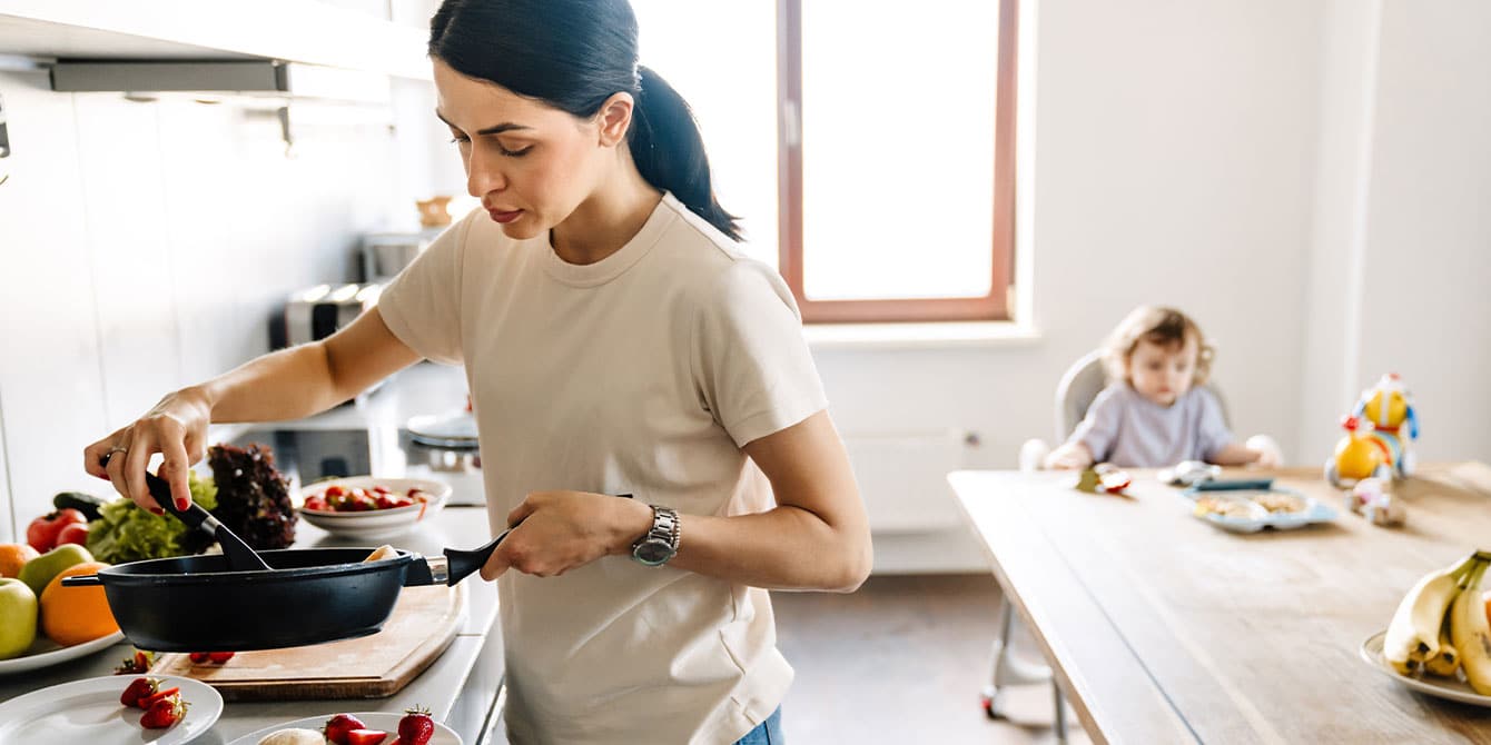 7 ways to help your kids form a healthy relationship with food mom cooking in the kitchen for her child to help kids have a healthy relationship with food
