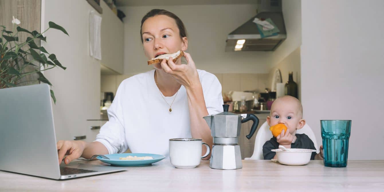 10 easy meals for busy moms—because moms got to eat too! mom eating toast while working and baby eating next to her- easy meals for busy moms