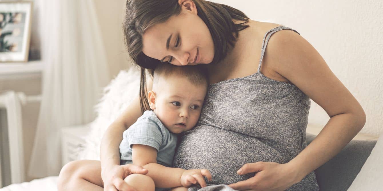 Flu vaccination rates in children and pregnant women are the lowest they’ve been in several seasons, CDC warns pregnant mother hugging toddler sun at home - flu shots offer protection to vulnerable populations like pregnant women and young children
