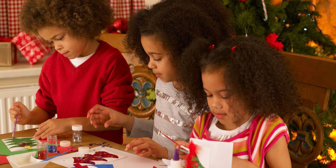 10 Christmas crafts for kids that’ll keep little hands busy this season 3 kids making christmas cards - christmas crafts for kids