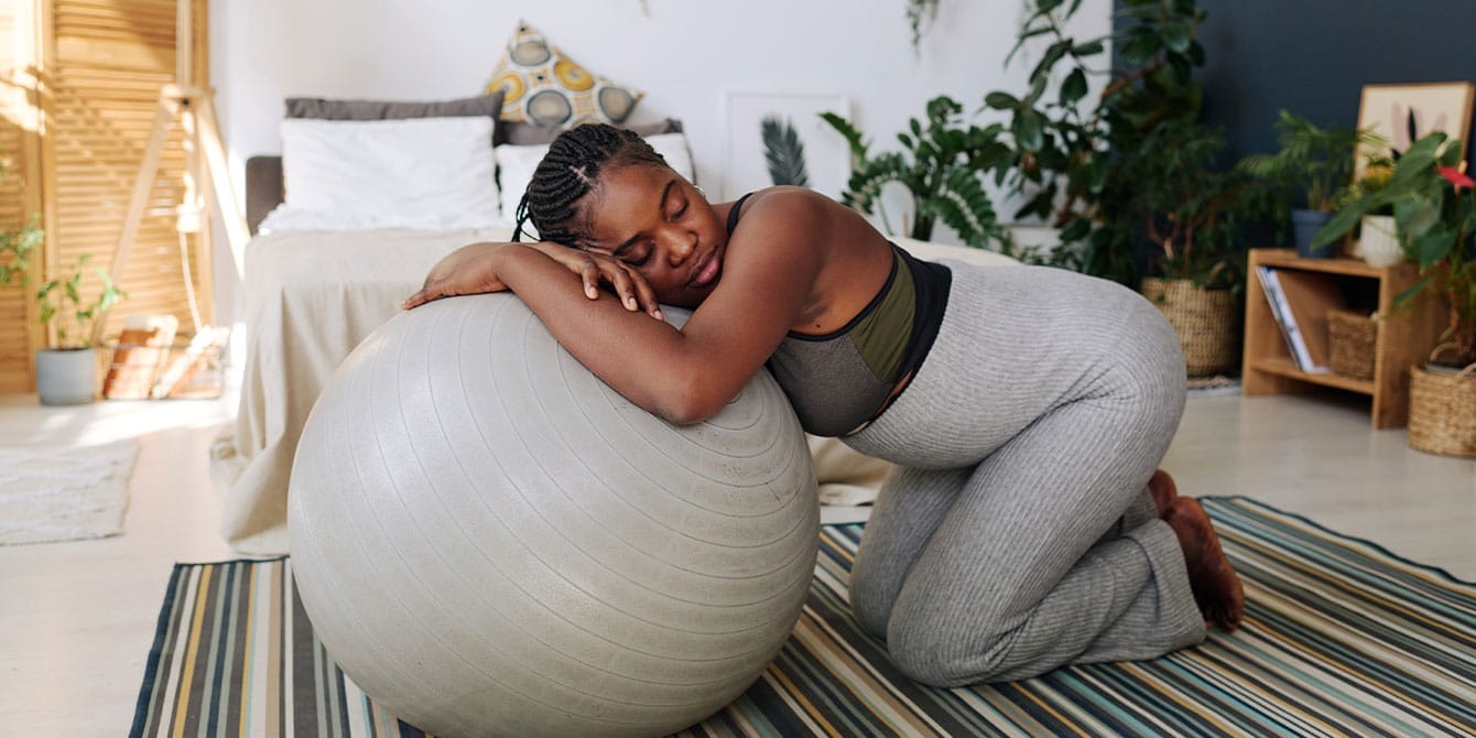 Try these 4 yoga poses to induce labor—safely pregnant woman doing yoga poses to induce labor at home
