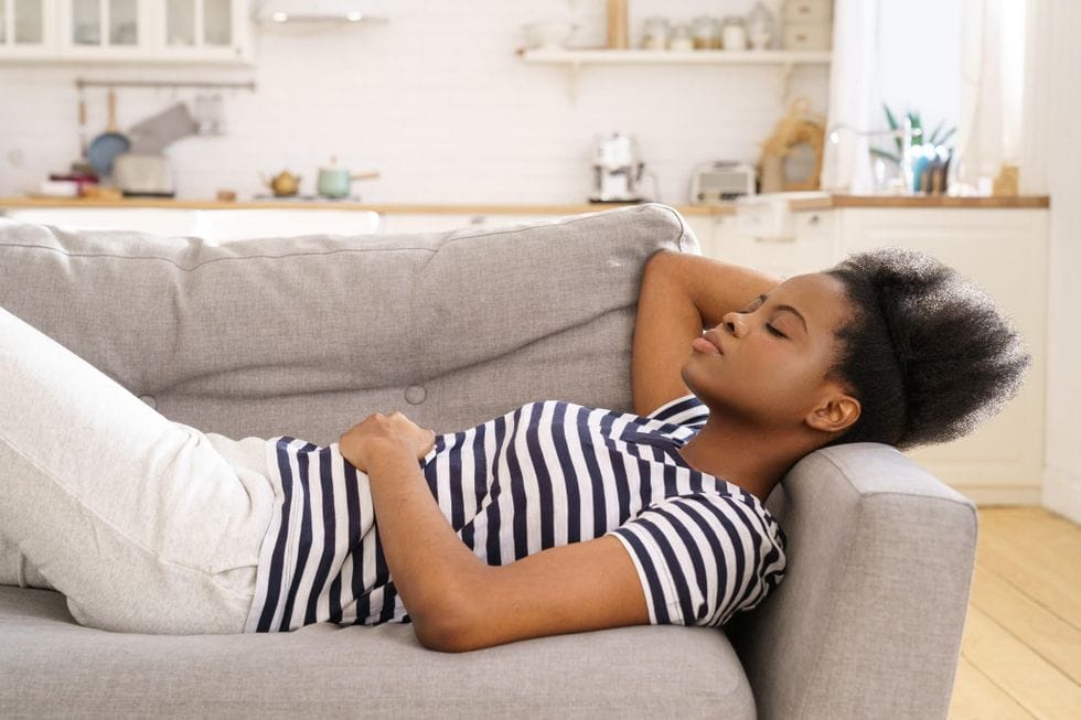 woman sleeping on couch - Motherly
