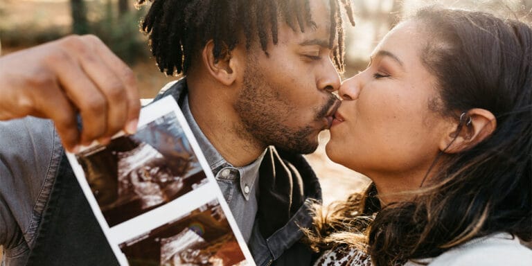 The top 5 male fertility supplements (plus when to start taking them) couple kissing while holding an ultrasound - best men's fertility supplements
