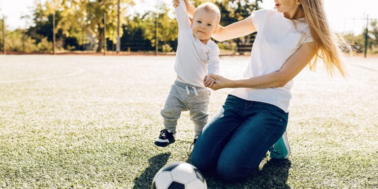 20 sporty baby names inspired by the World Cup and athletes all over the globe mom and son playing soccer- sporty baby names