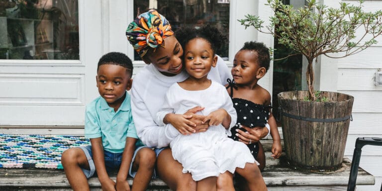 Motherhood feels different the third time around mom of three playing outside with her children