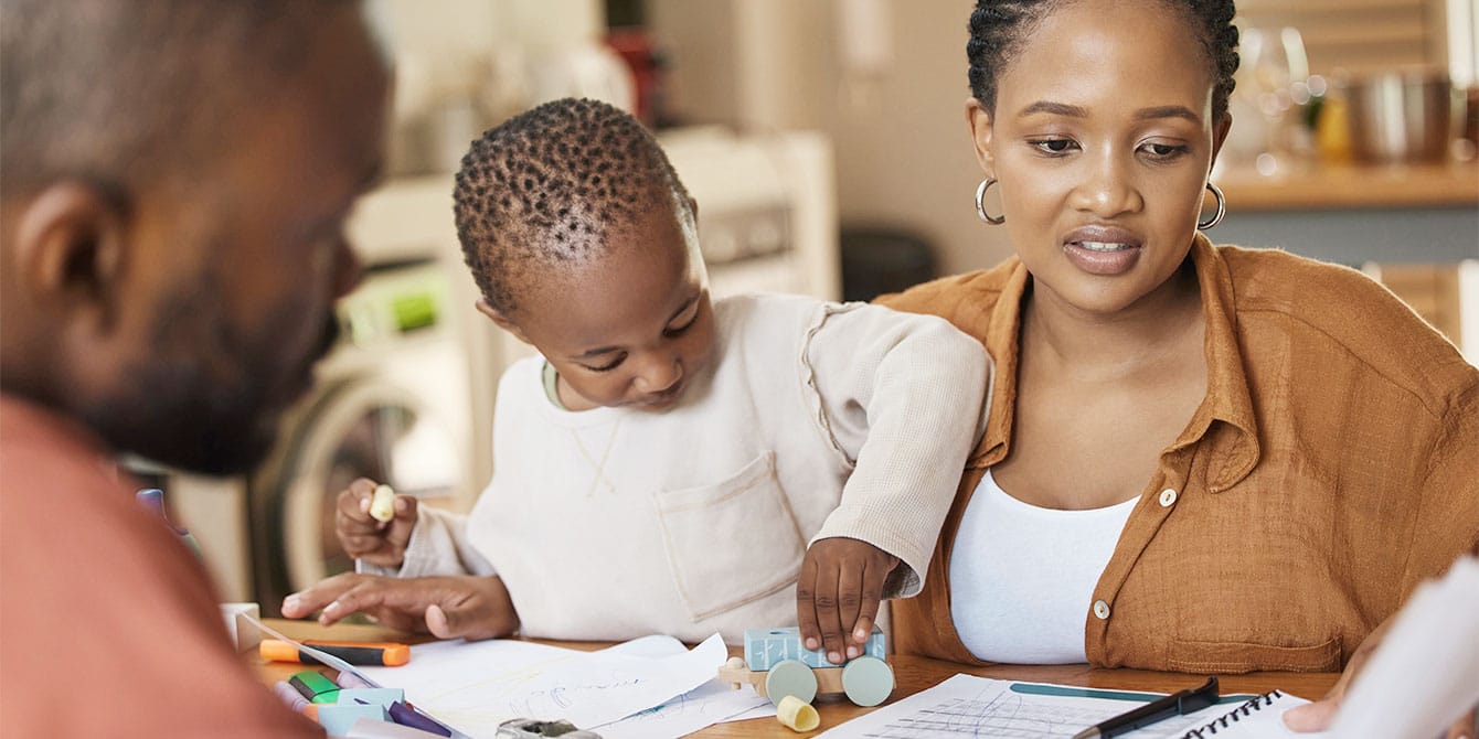 What parents need to know about filing their 2023 taxes parents at the dining table looking at papers-filing 2023 taxes