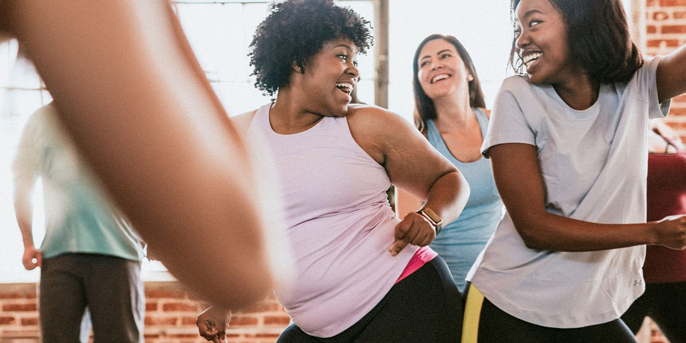 I’ve had 4 tough pregnancies. Of all things, Jazzercise kept me going Two women laughing in dance cardio class - jazzercise in pregnancy