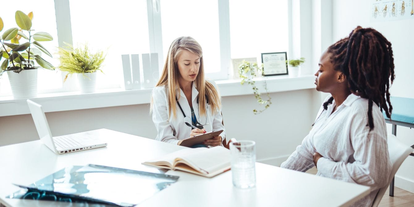 Feeling dismissed by your doctor? Medical gaslighting can be common in women’s health woman meeting with doctor in office - medical gaslighting is common in women's health
