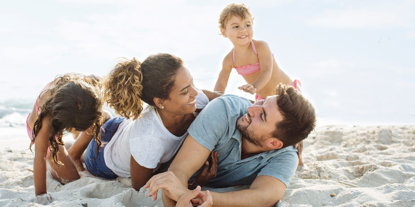 4 reasons to travel with your kids—even if you think they won’t remember it family enjoying vacation - reasons to travel with kids
