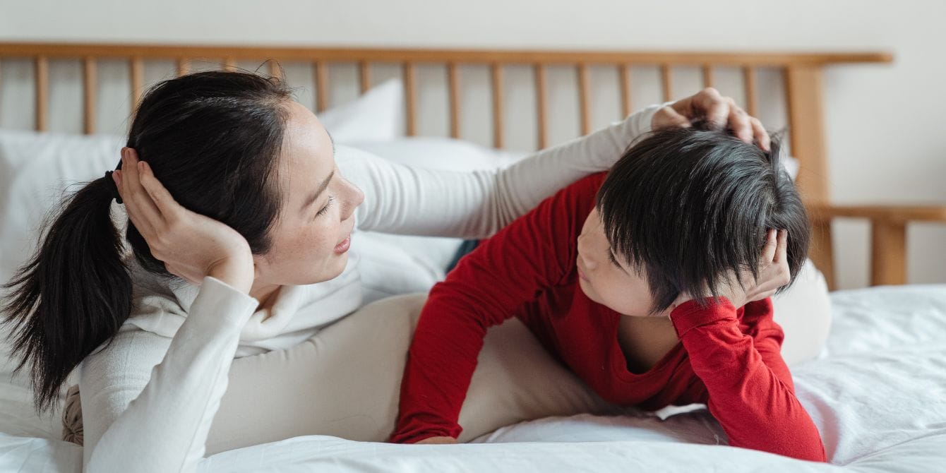 How to talk to kids about periods: An age-by-age guide mom talking to son on bed - how to talk to kids about periods