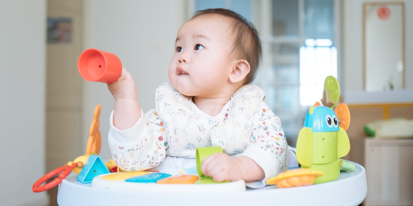 Activities for an 11-month-old: Fostering baby’s development 11-month-old baby playing at activity table - activities for 11-month-old