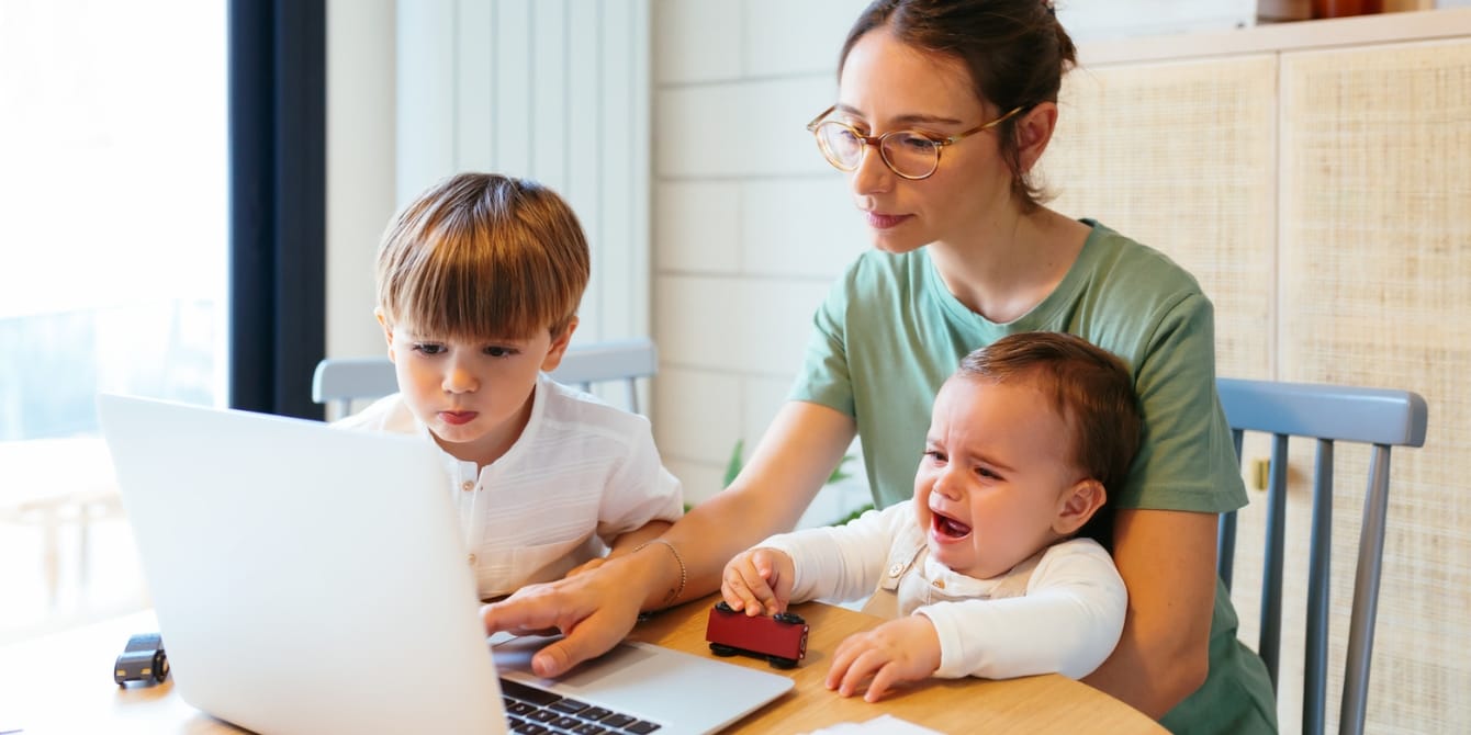 What are Buy Nothing groups? These online communities can help you get secondhand goods for free mother and children looking at buy nothing groups on a laptop