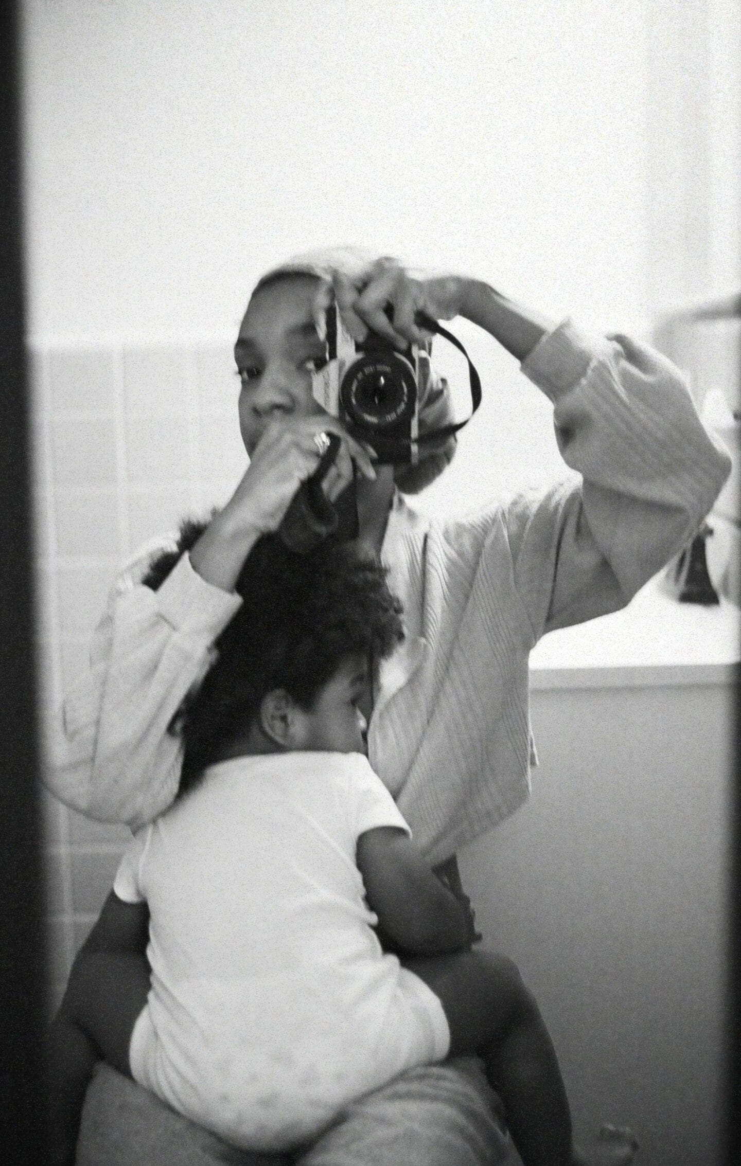 mother taking photo with baby - Motherly