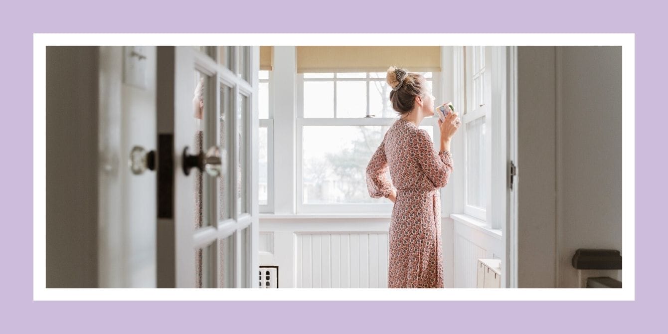 What do moms want for Mother’s Day? To be left completely alone Mom looking out window in robe drinking coffee