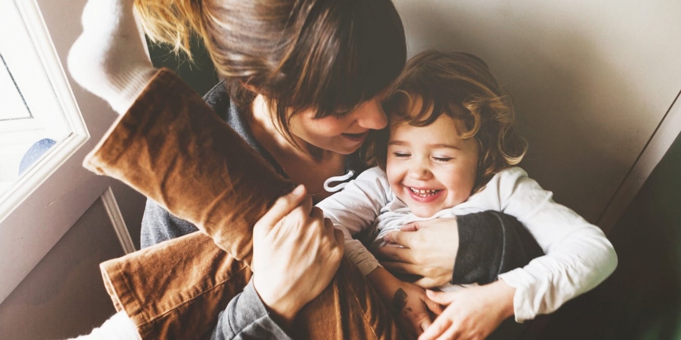 Real talk: Toddlers are hard mom holding toddler needing toddler parenting advice for a hard toddler