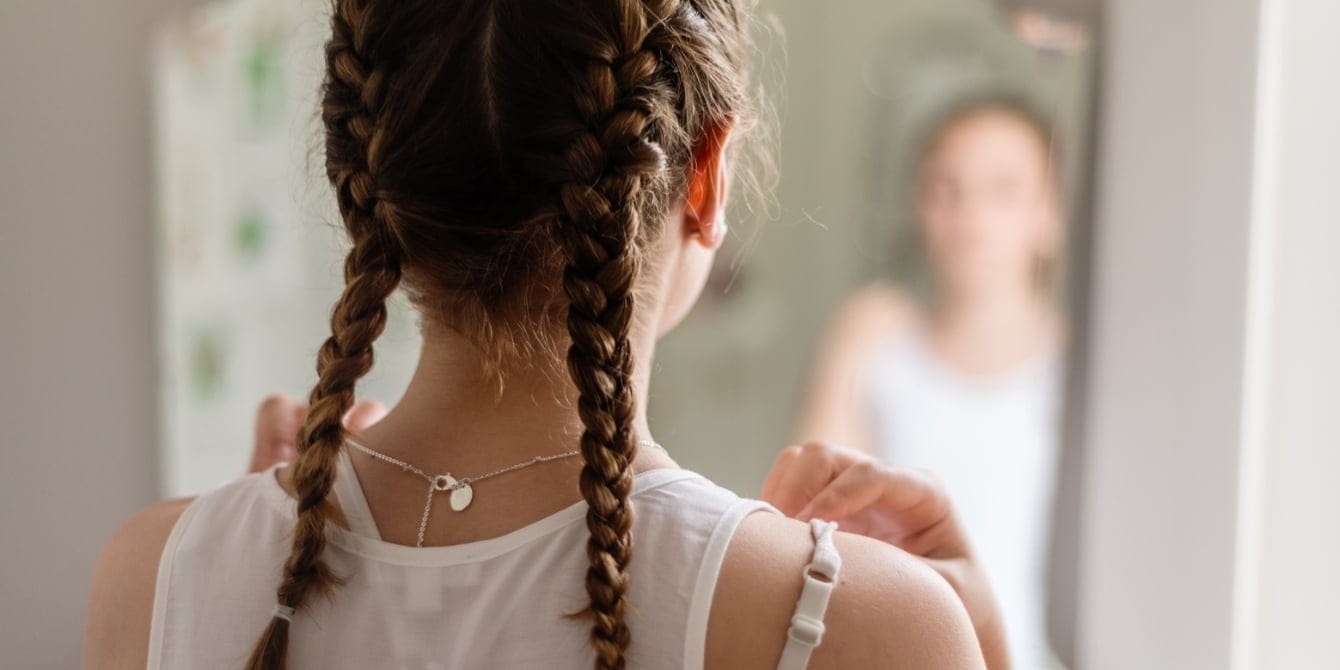 Spotting the signs of eating disorders in kids and teens Tween girl looking in the mirror - Spotting the signs of eating disorders in kids and teens