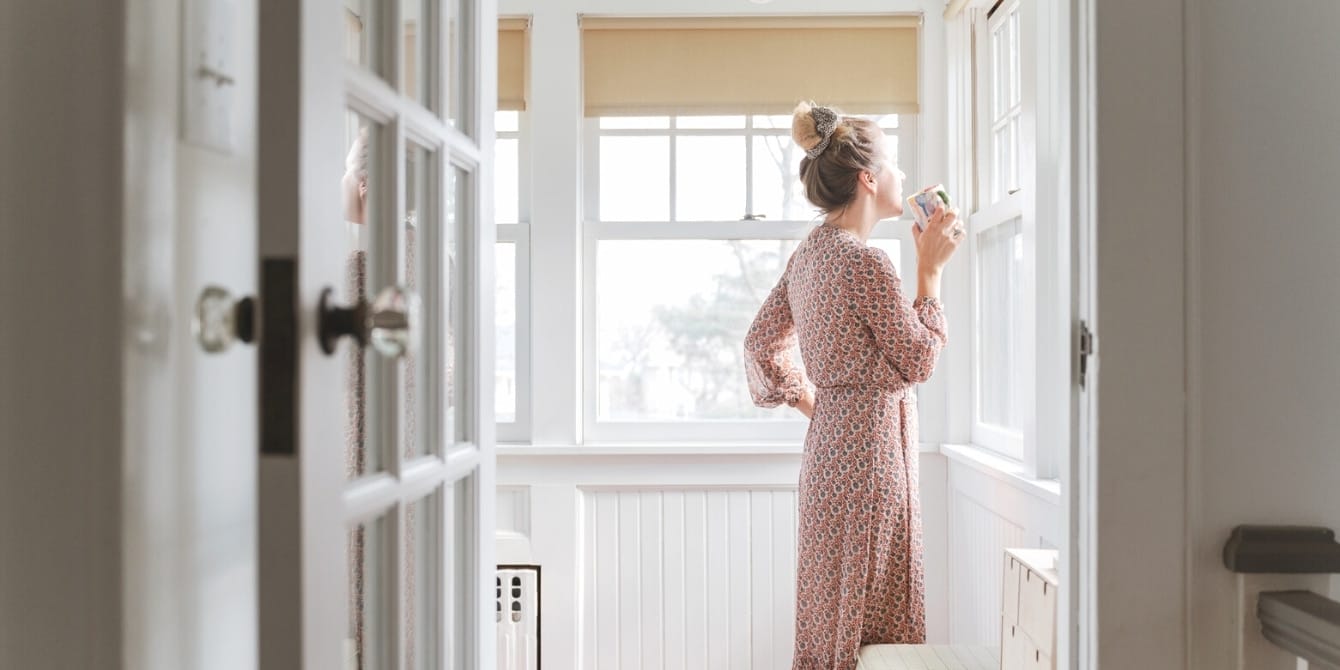The grief of divorce hit me most when it came to sharing custody woman looking outside the window- divorce grief