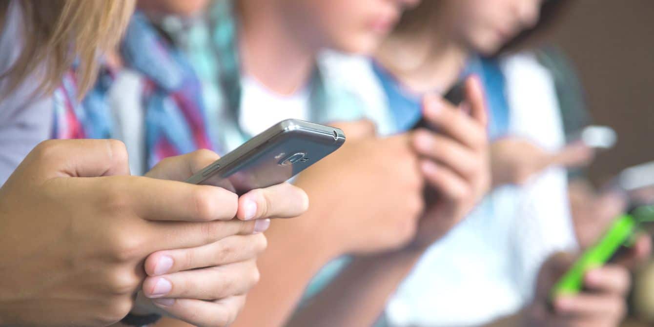 Popular ‘Saturn’ app for students sparks concern over online safety and predators Kids on their phones at school