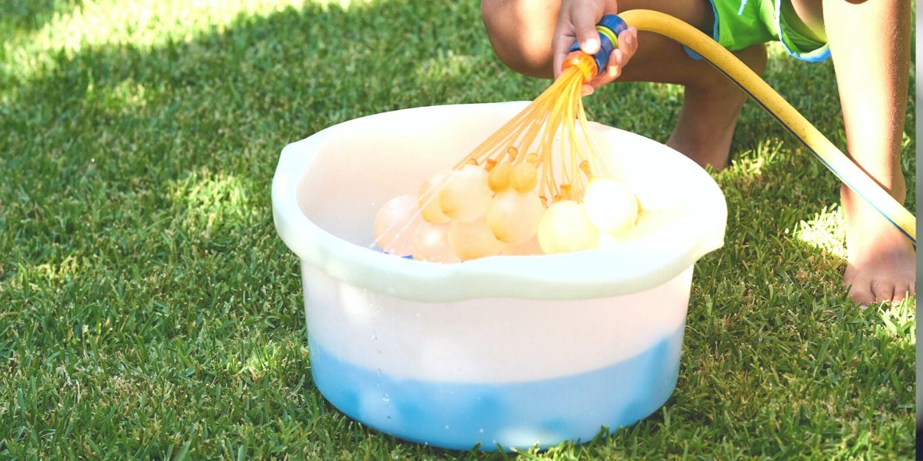 AAP warns parents about major safety risk of magnets found in reusable water balloons Boy fills up bucket of reusable water balloons