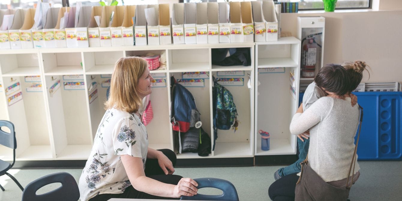 Here’s what to do if the childcare cliff impacts your family, according to experts Mom embraces child at childcare center