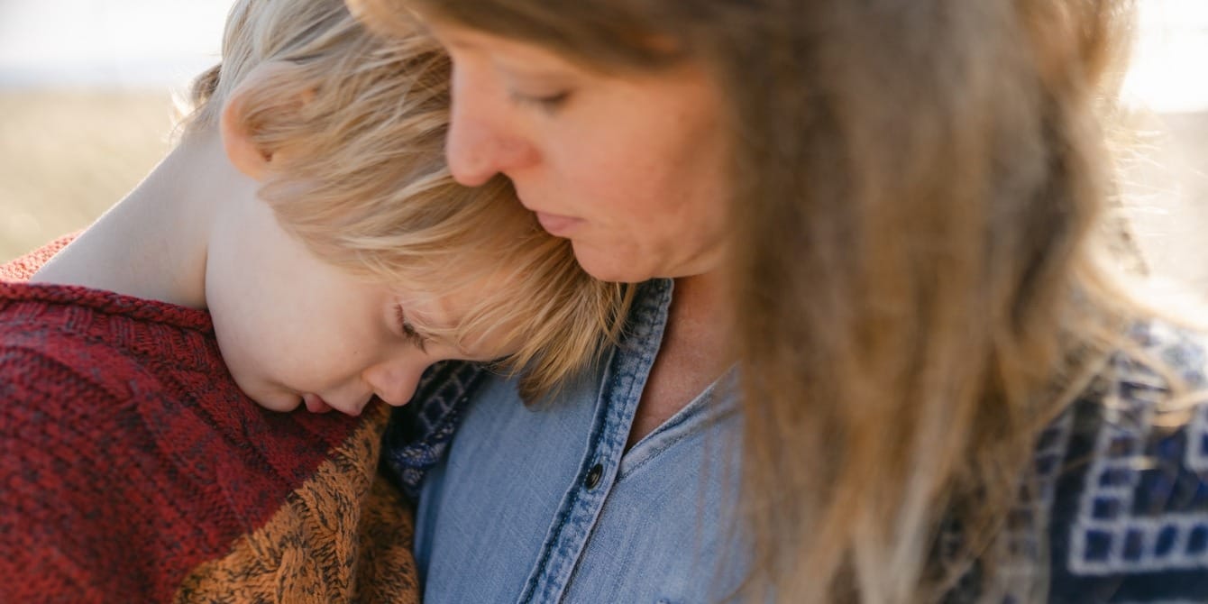 6 tips for raising highly sensitive children—from a therapist and mom closeup mother comforting young son - raising highly sensitive children