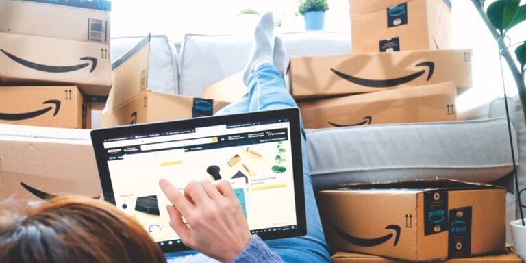 40 Amazon Prime Big Deal Days deals that will get your home and gift list ready for the holidays woman shopping Amazon Prime Big deal days on ipad
