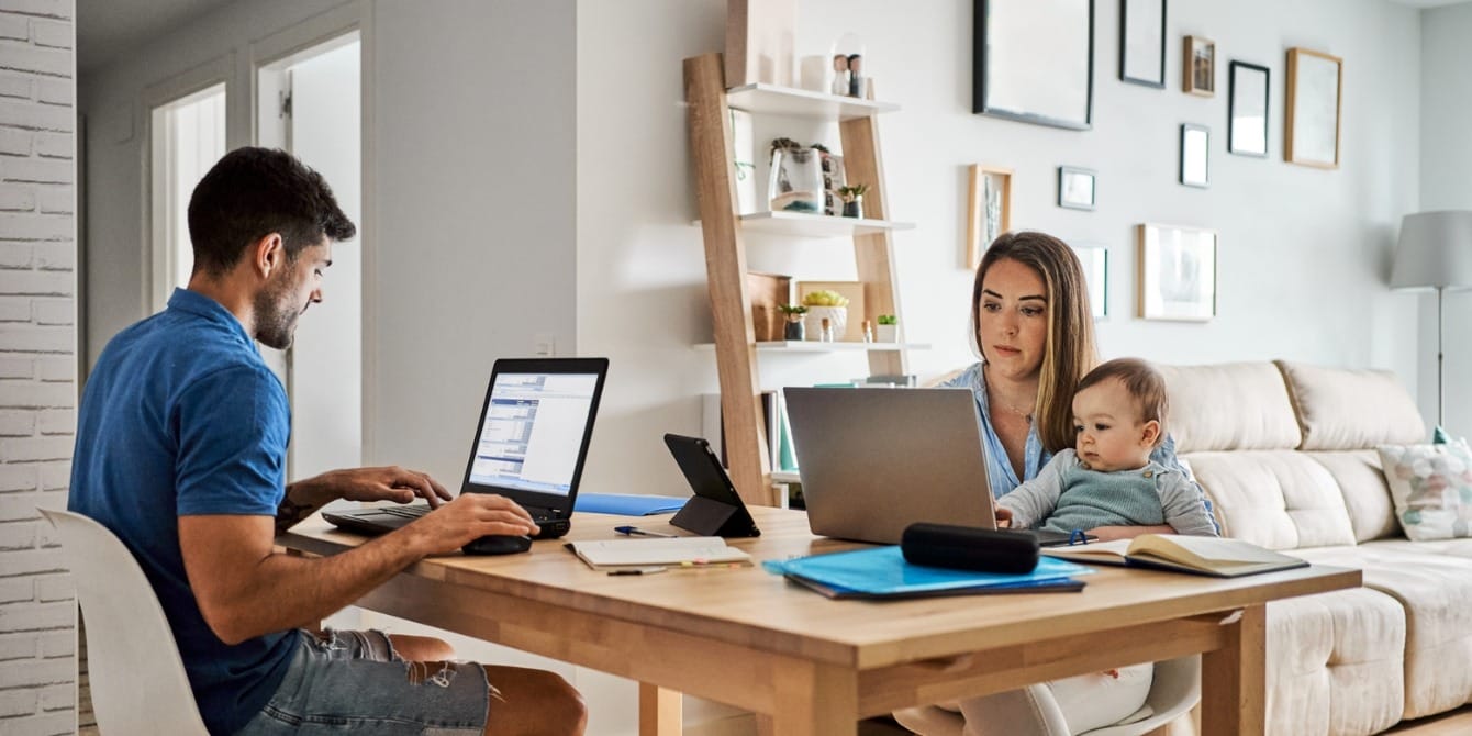 Supporting working parents is good for business, full stop young parents with baby working at home - supporting working parents