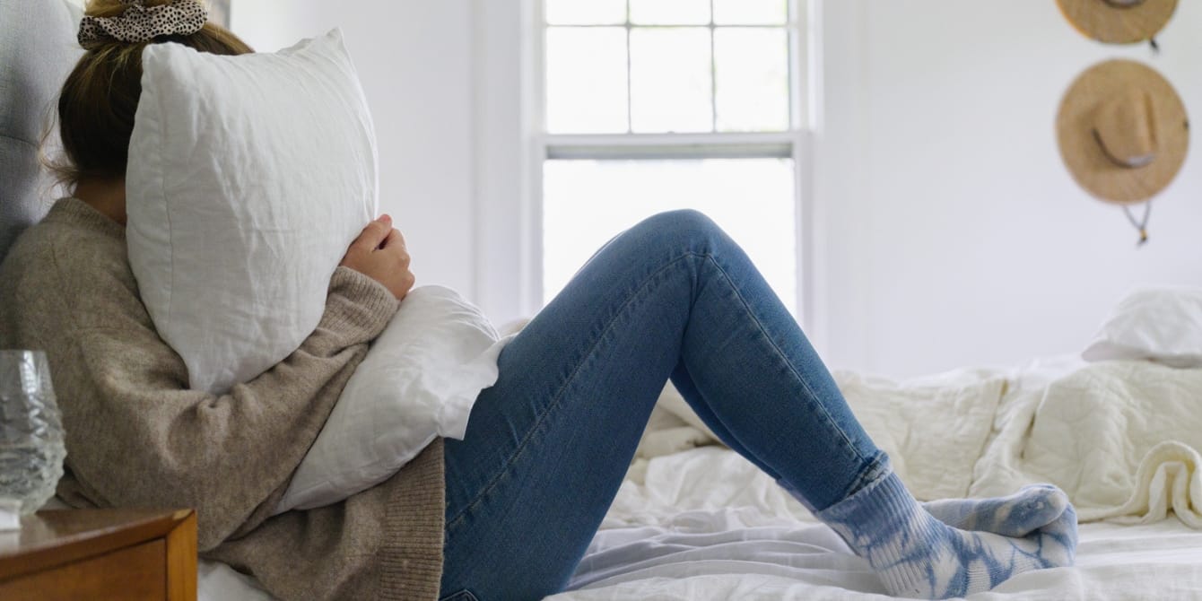 California’s new law allows mothers to take 5 days off for ‘reproductive loss’ Woman Burying Her Face In A Pillow On Bed California reproductive loss leave sb 848 parental leave