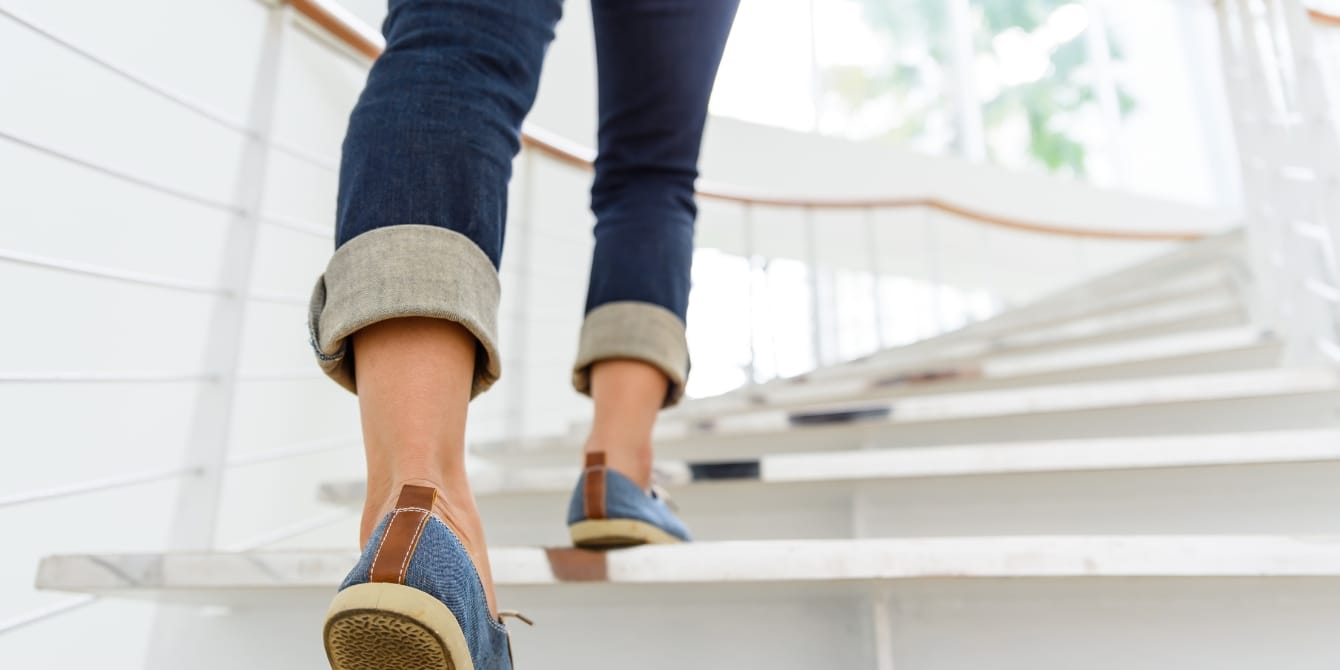 This app will pay you to take a walk woman walking upstairs - weward app