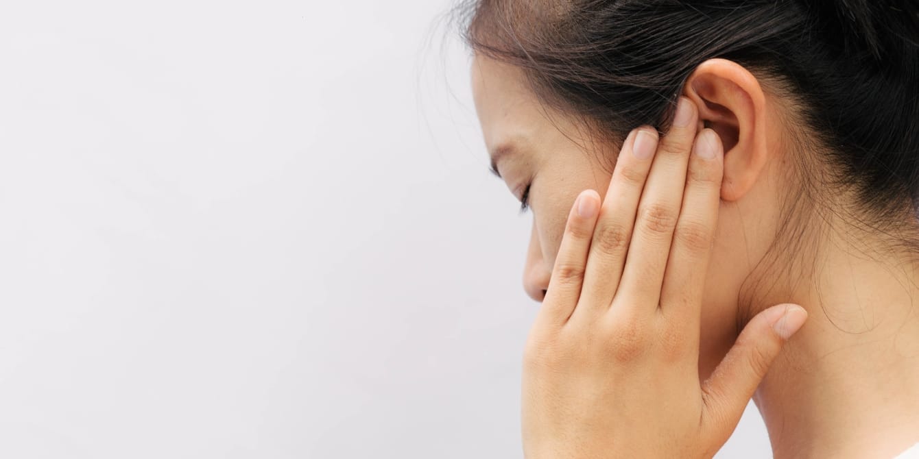 I developed a strange postpartum condition where I started to hear music–everywhere, all the time asian woman holding her ear - musical ear