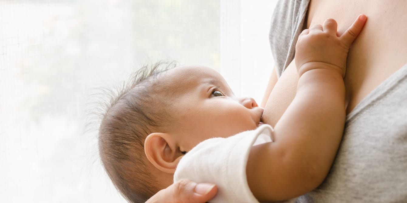 The actual cost of breastfeeding might shock you close up mother breastfeeding baby - cost of breastfeeding