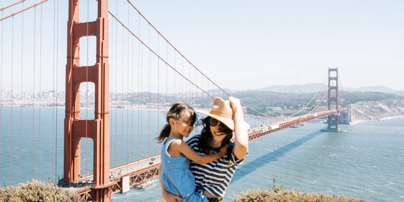 Staycation vs vacation: 5 reasons to stay local mom and daughter by golden gate bridge- staycation vs vacation