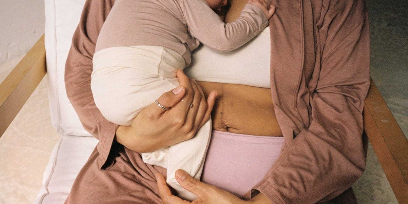 How postpartum pain gave me purpose postpartum mom holding baby in her underwear - postpartum pain