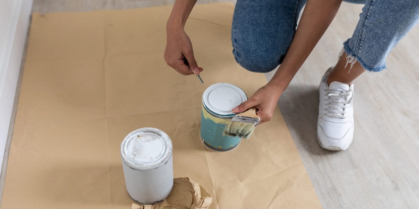 2024 color trends: All the colors of the year we know so far woman opening paint- 2024 color of the year