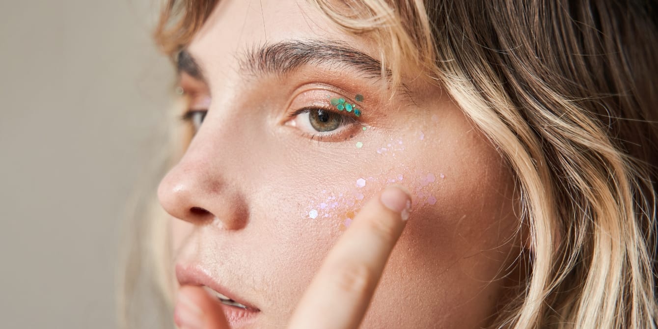 PSA: European Union officially bans glitter woman putting on glitter makeup - EU glitter ban