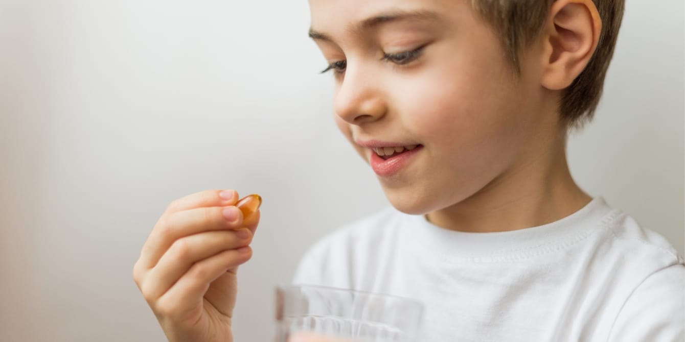 Pediatric dietitian shares creative way to get kids to swallow pills young boy holding pill get kids to swallow pills how to help kids swallow pills