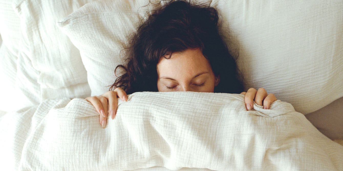 Daylight Savings Time is about to do a number on your body—here’s how Woman sleeping