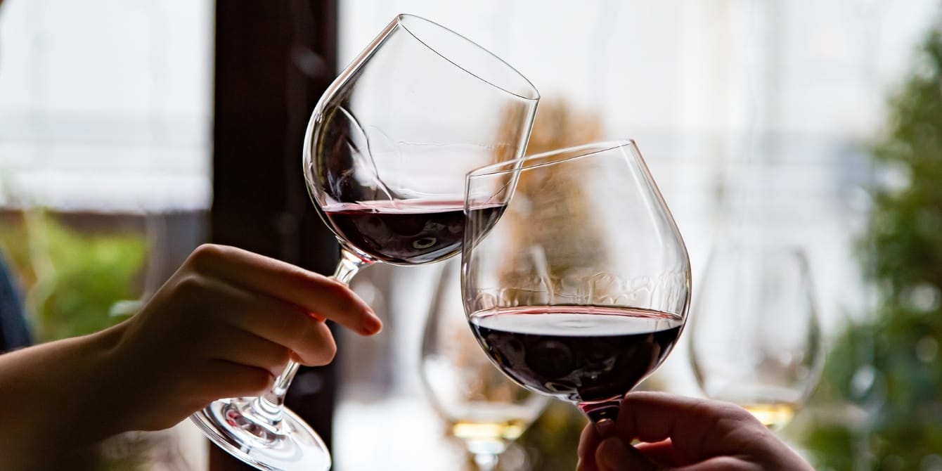 Does red wine give you headaches? Researchers pinpoint the culprit hands young couple clinking with glasses of red wine headaches