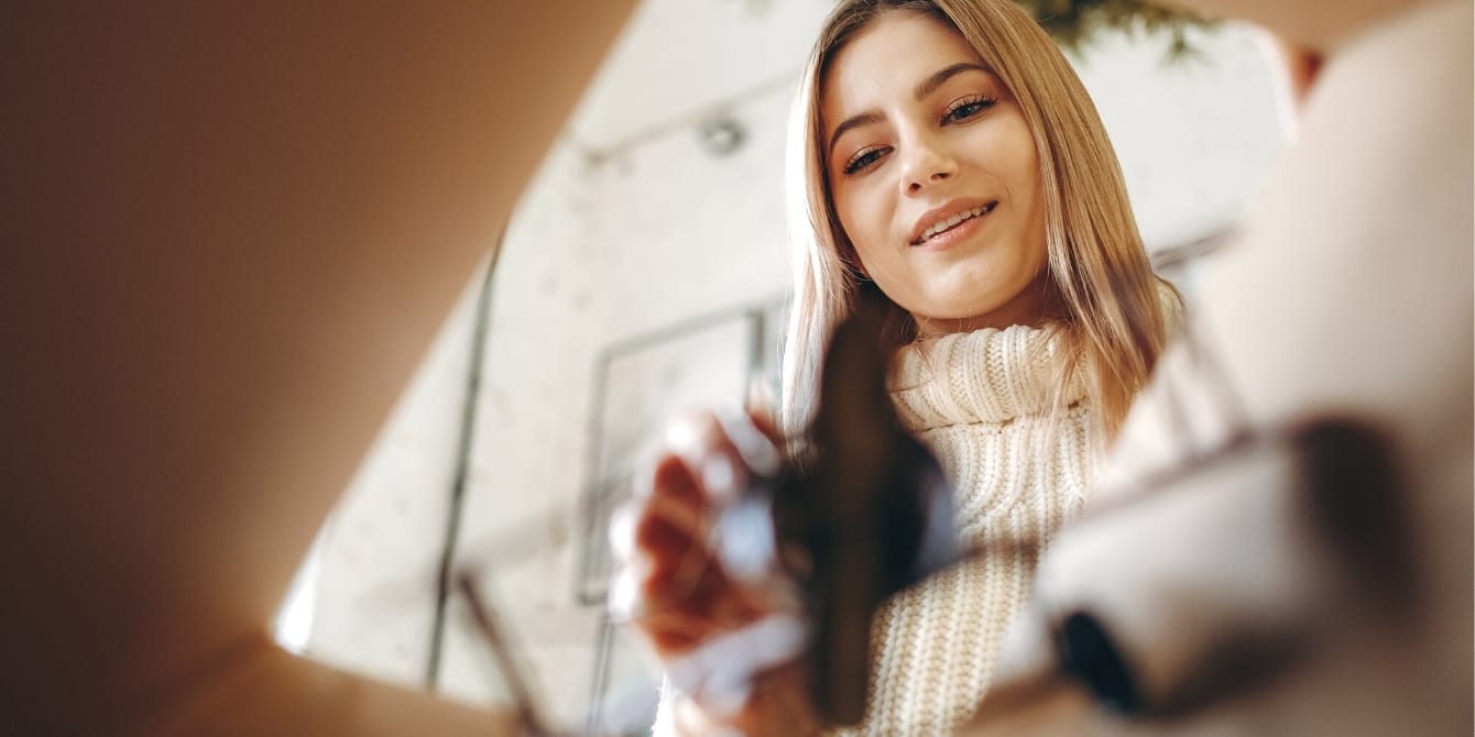 Buy Nothing: how my local Facebook group is saving the holiday season woman taking gifts out of a box- buy nothing gift