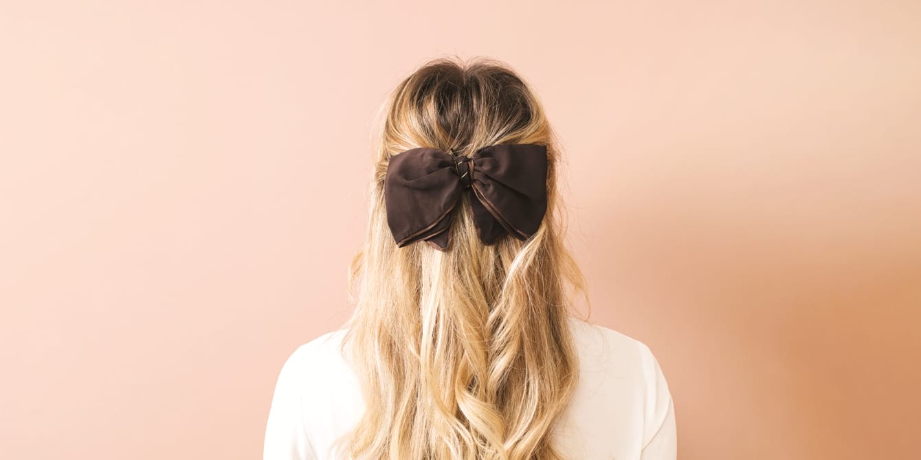 The hair bow trend has us swooning woman with hair bow trend