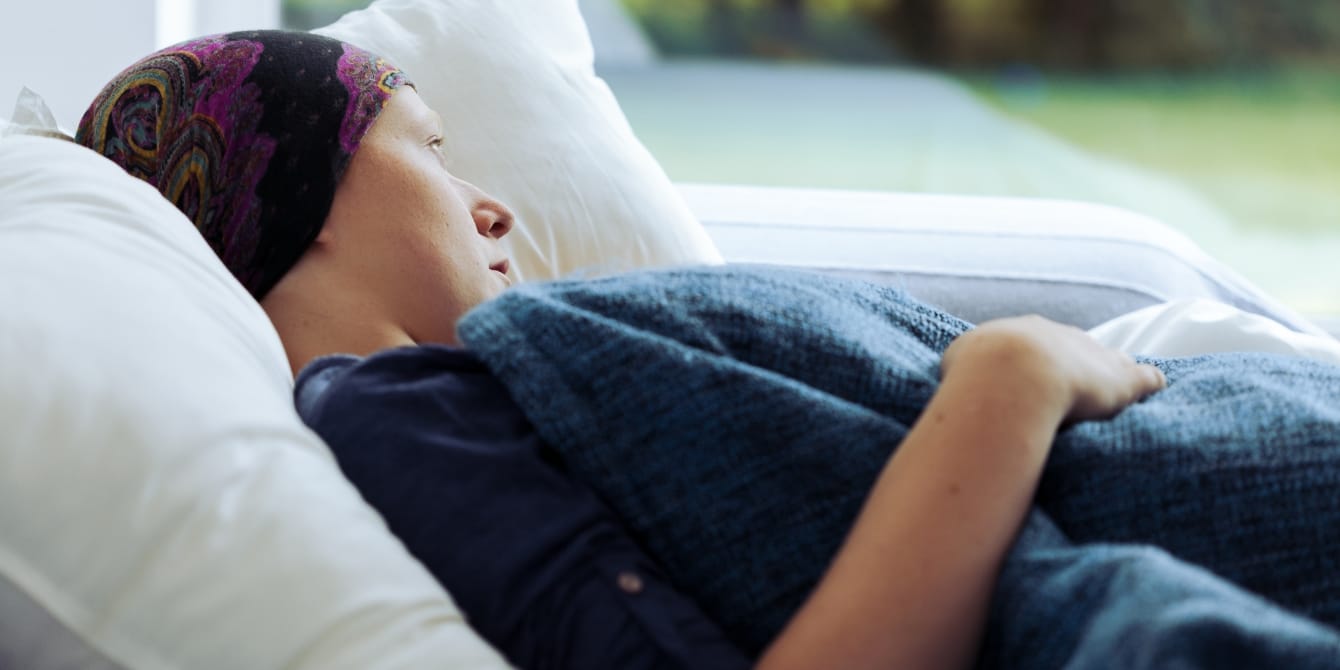 3 lessons I’ve learned as a lupus warrior—and a lupus mom Thoughtful woman battling with lupus looking out of window at home lupus mom