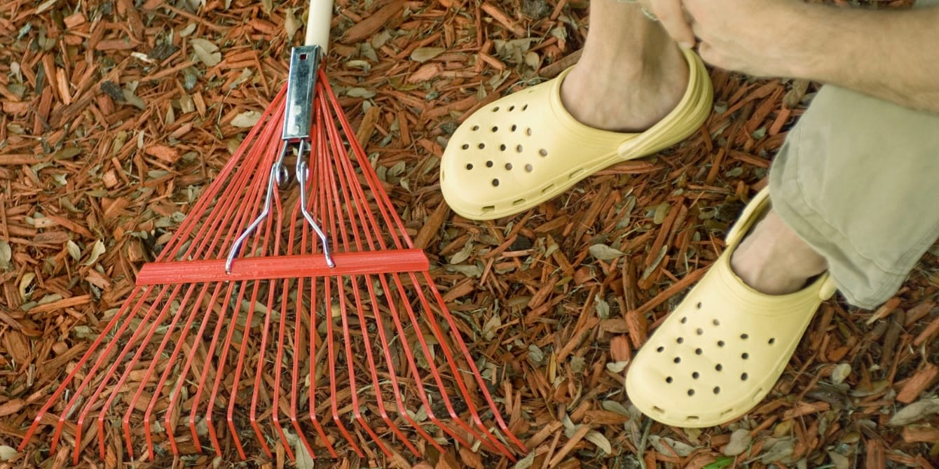 Redditor warned against installing potentially harmful rubber mulch in yard rake and persons feet on mulch