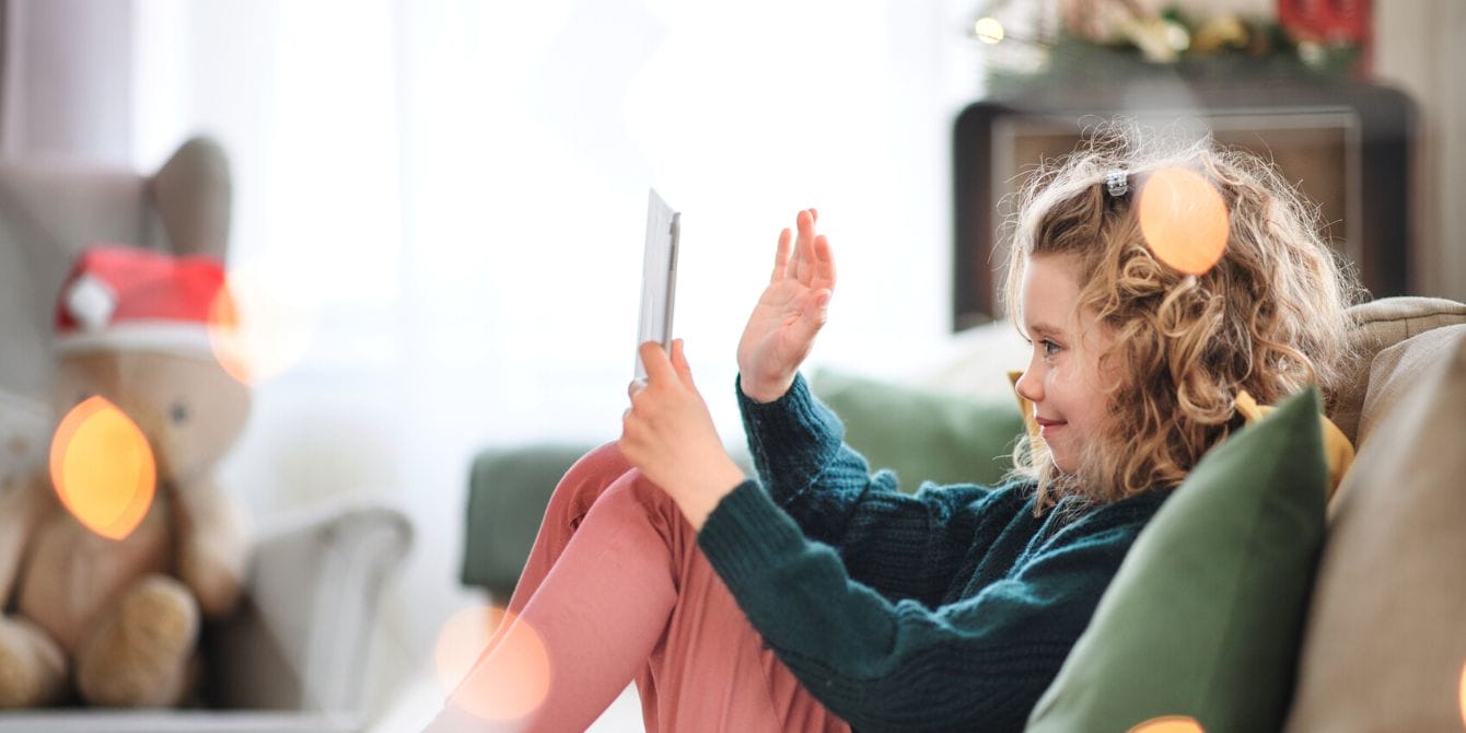 Dr. Becky’s tips for setting screen time boundaries during the holidays are a lifesaver Girl on ipad at Christmas