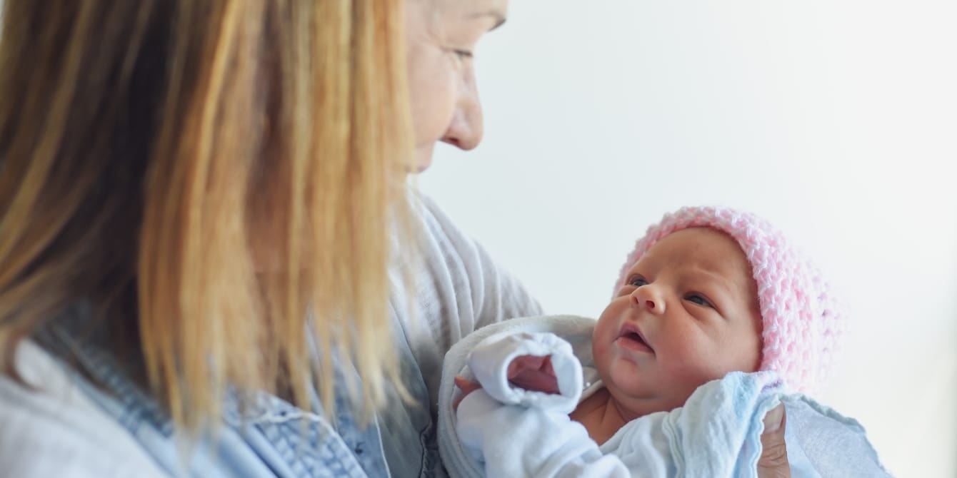 Moms are divided over a new party trend called ‘grandma showers’ grandma holding newborn baby grandma showers