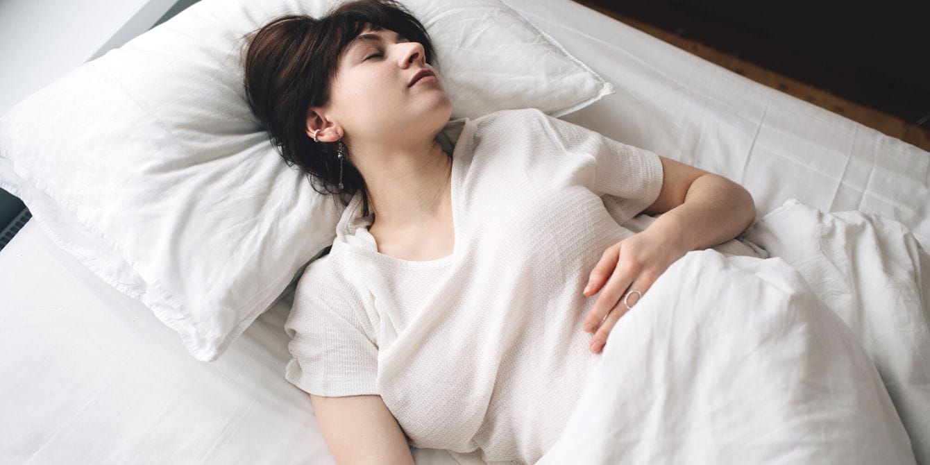 Research has FINALLY pinpointed the cause of severe morning sickness Woman with morning sickness in bed