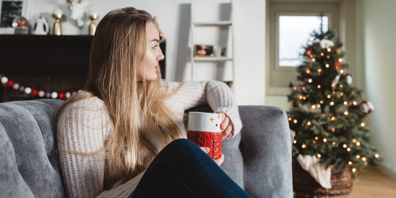 From overwhelm to joy: A mom’s guide to nervous system health this holiday season woman sitting on couch looking serious nervous system health