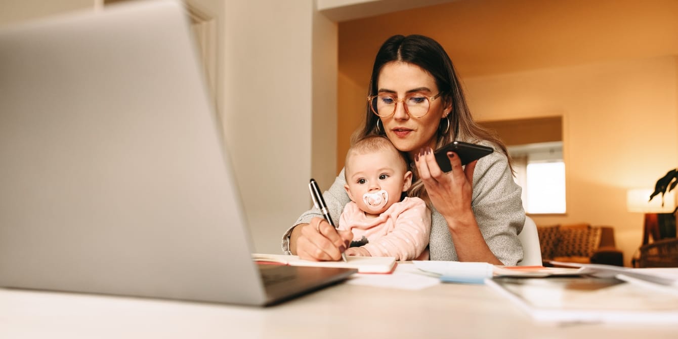 Balancing a newborn and working full-time working mom holding baby - balancing a newborn and working